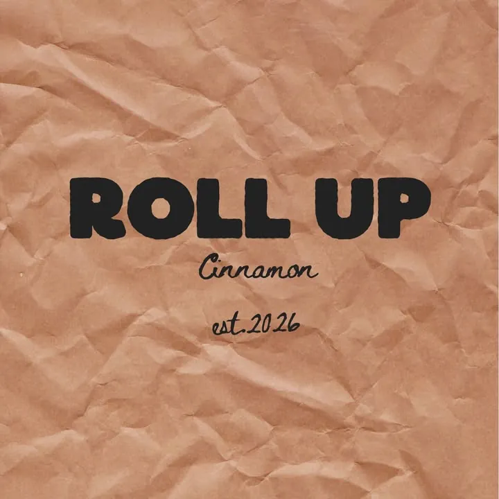 The Roll Up Cinnamon logo on crumpled kraft paper